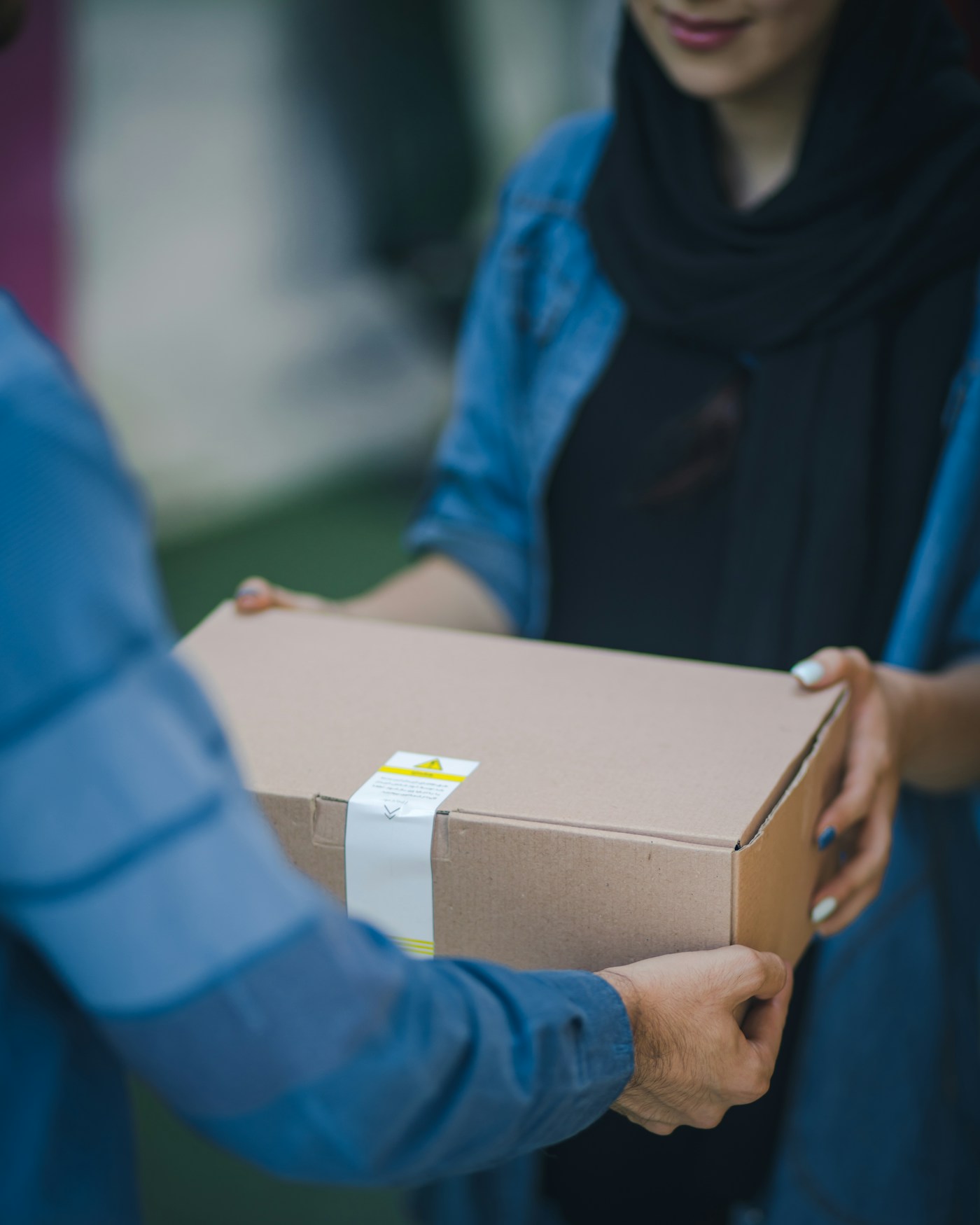Partners handing over a packaged retail shipment